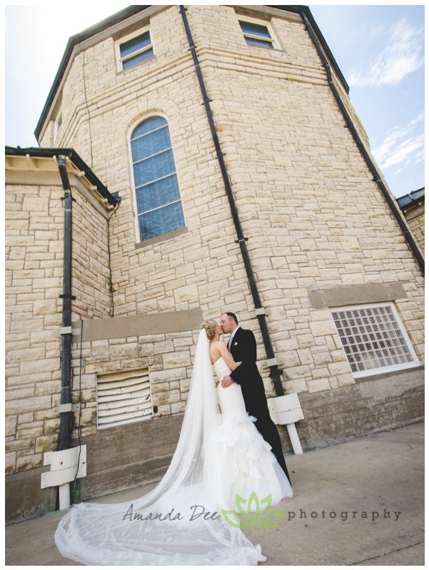 wedding photo bride and groom wide shot with church in background