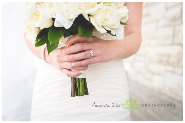 wedding photo of bride holding bouquet close up of ring
