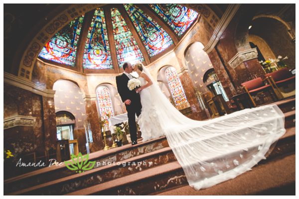 wedding photo of bride and groom at the alter in church wide