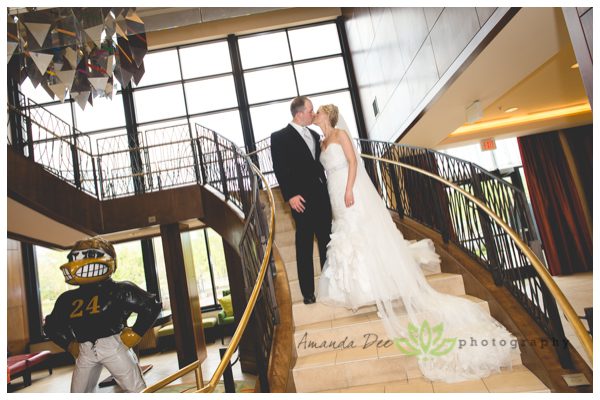 bride and groom on staircase kissing