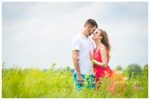 Outdoor engagement photos tall green gassy field sweet candid nose to nose