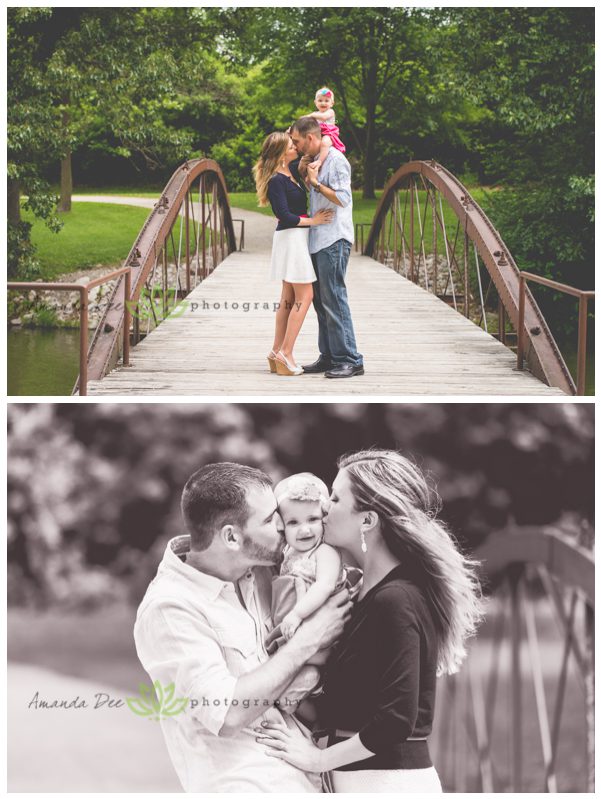 Outdoor family session with baby on dads shoulders mom and dad kissing baby black and white