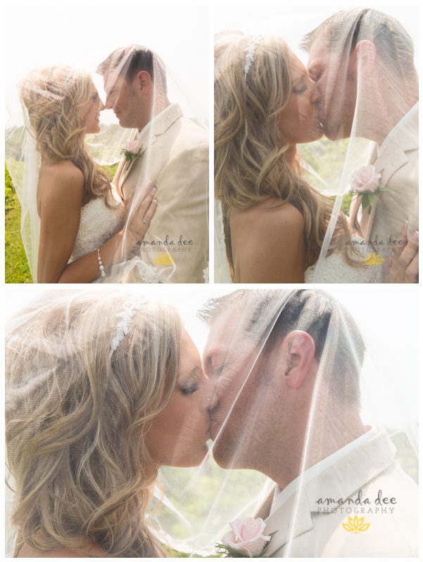 Summer Wedding Amanda Dee Photography bride and groom under veil kissing outside at winery in vineyard