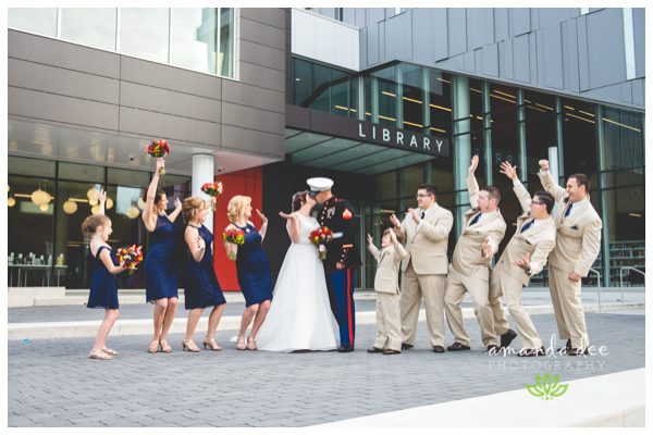 Sunset Downtown Library Rooftop Wedding Amanda Dee Photography Wedding Party cheering on a kiss outside downtown library